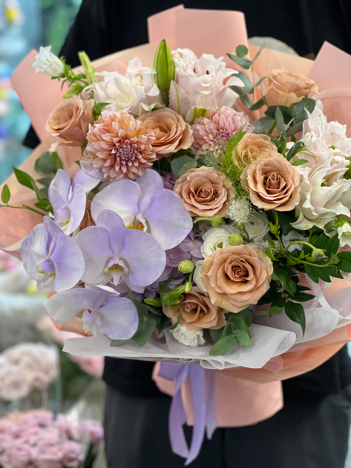 Reflower HK elegant mixed bouquet featuring purple Phalaenopsis orchids, peach roses, and dahlias, wrapped in peach paper with a lavender ribbon, perfect for Mother's Day and elder birthdays.