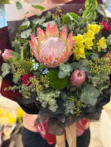 Reflower HK premium South African King Protea bouquet with yellow Alstroemeria and blue eryngium, wrapped in masculine black and burgundy paper, perfect for gifts for him and promotions.