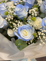 Reflower HK dreamy bouquet featuring 11 gradient ice blue roses, tweedia, and baby's breath, wrapped in elegant translucent white paper.