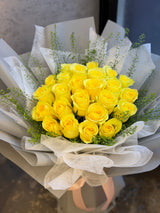 Reflower HK cheerful bouquet featuring 24 vibrant yellow roses and fresh green bell, wrapped in elegant light grey paper with white organza and a pale pink ribbon.